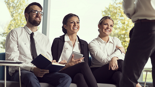 Group of job applicants sitting and listening to someone